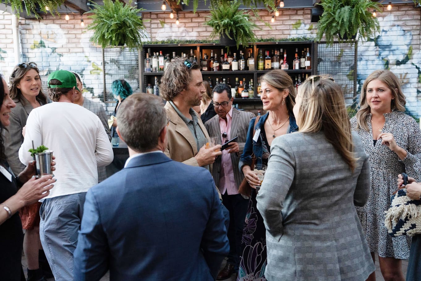 Guests talking at an evening corporate event covered by DHC Media in Denver.